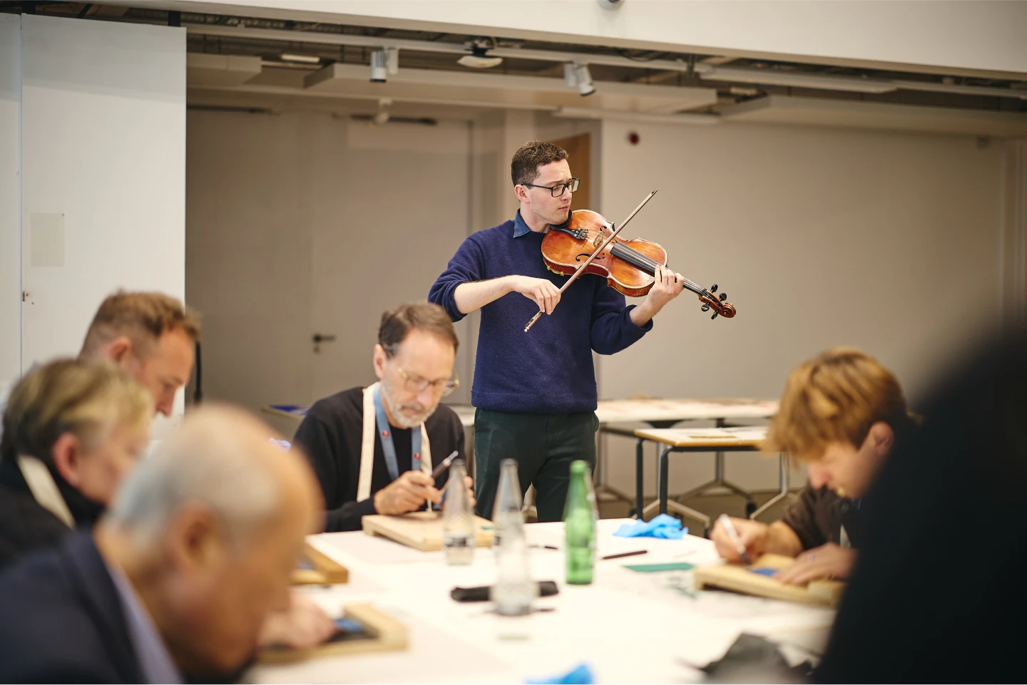 A person playing a violin in the background